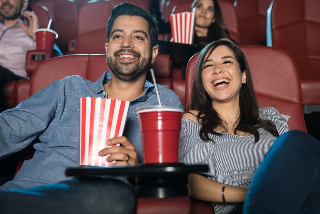 a couple at the cinema laughing