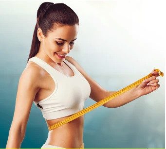 brunette measuring her waist