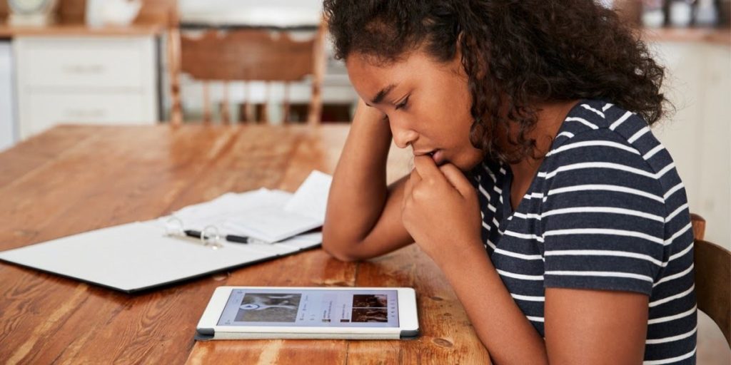 little girl scrolling anxiously through Instagram