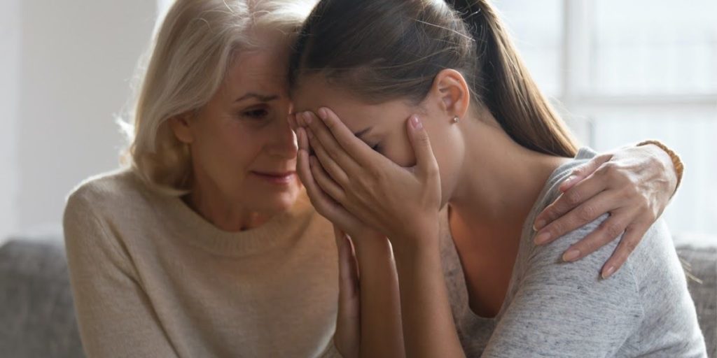 mom consoling daughter