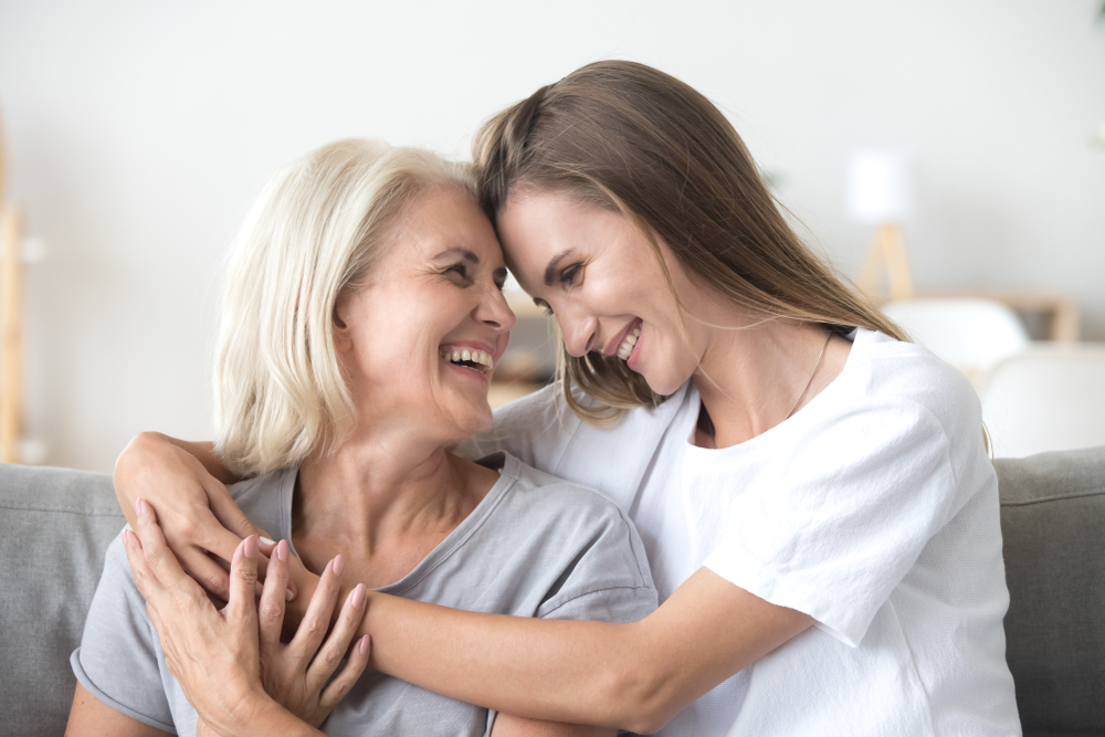 mum and daughter embracing eachother and smiling