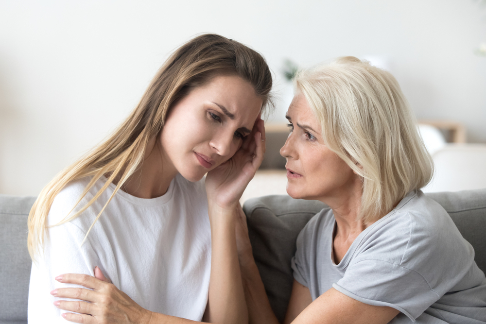 mum comforting daughter who looks preoccupied