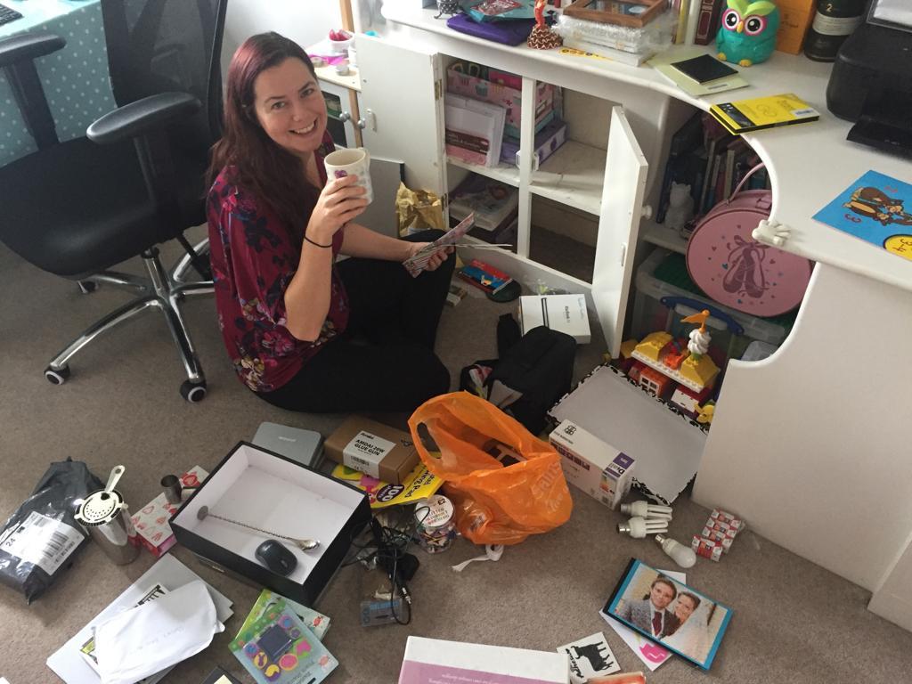 woman in a messy room drinnking tea