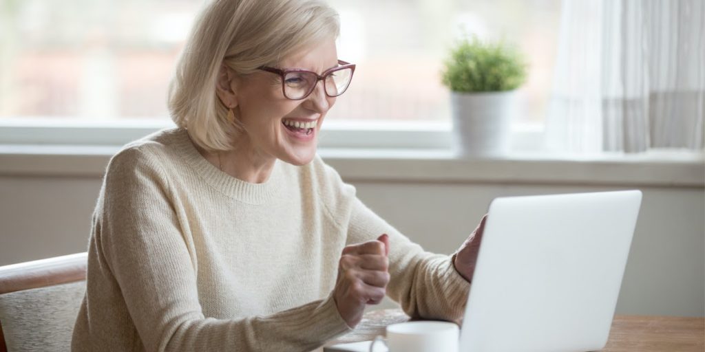 woman smiling at laptop